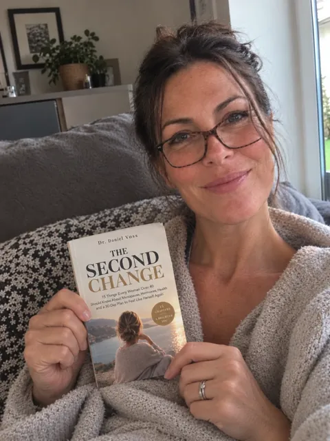 Woman holding The Second Change at home